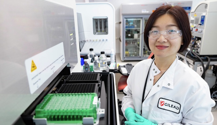 A Gilead scientist smiling in a laboratory