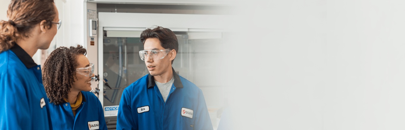 Gilead laboratory researchers wearing protective glasses and blue lab coats