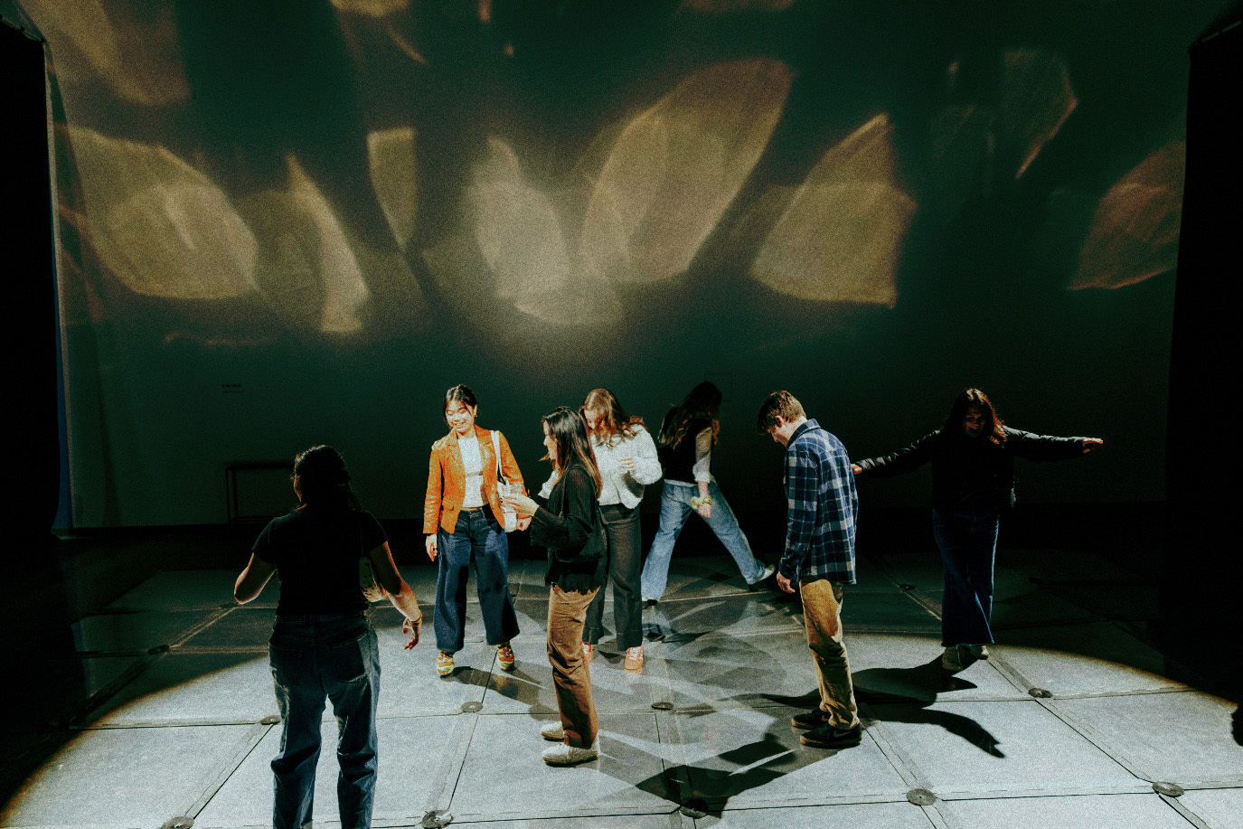 People exploring an immersive projection space in a photograph supplied by The Craftsman