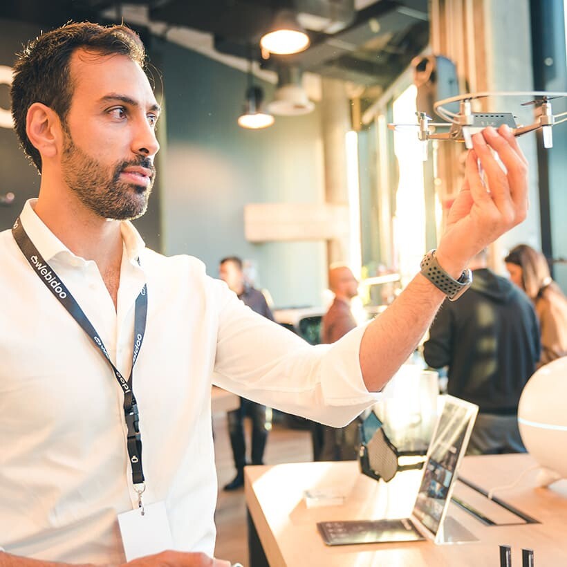 Giovanni Farese examines a small drone inside the Webidoo technology experience store