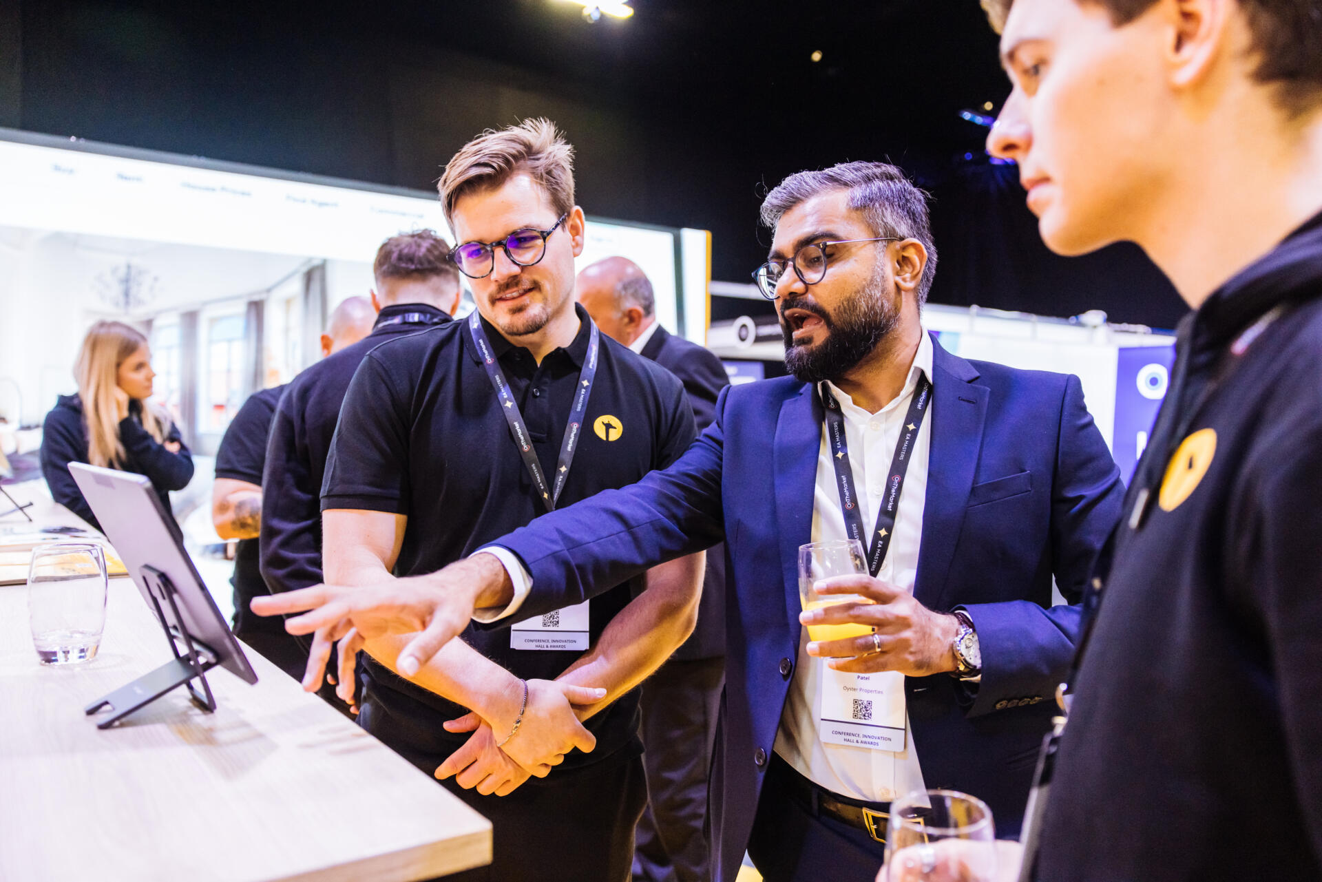 Giraffe360 representatives demonstrate a property interface to an event visitor