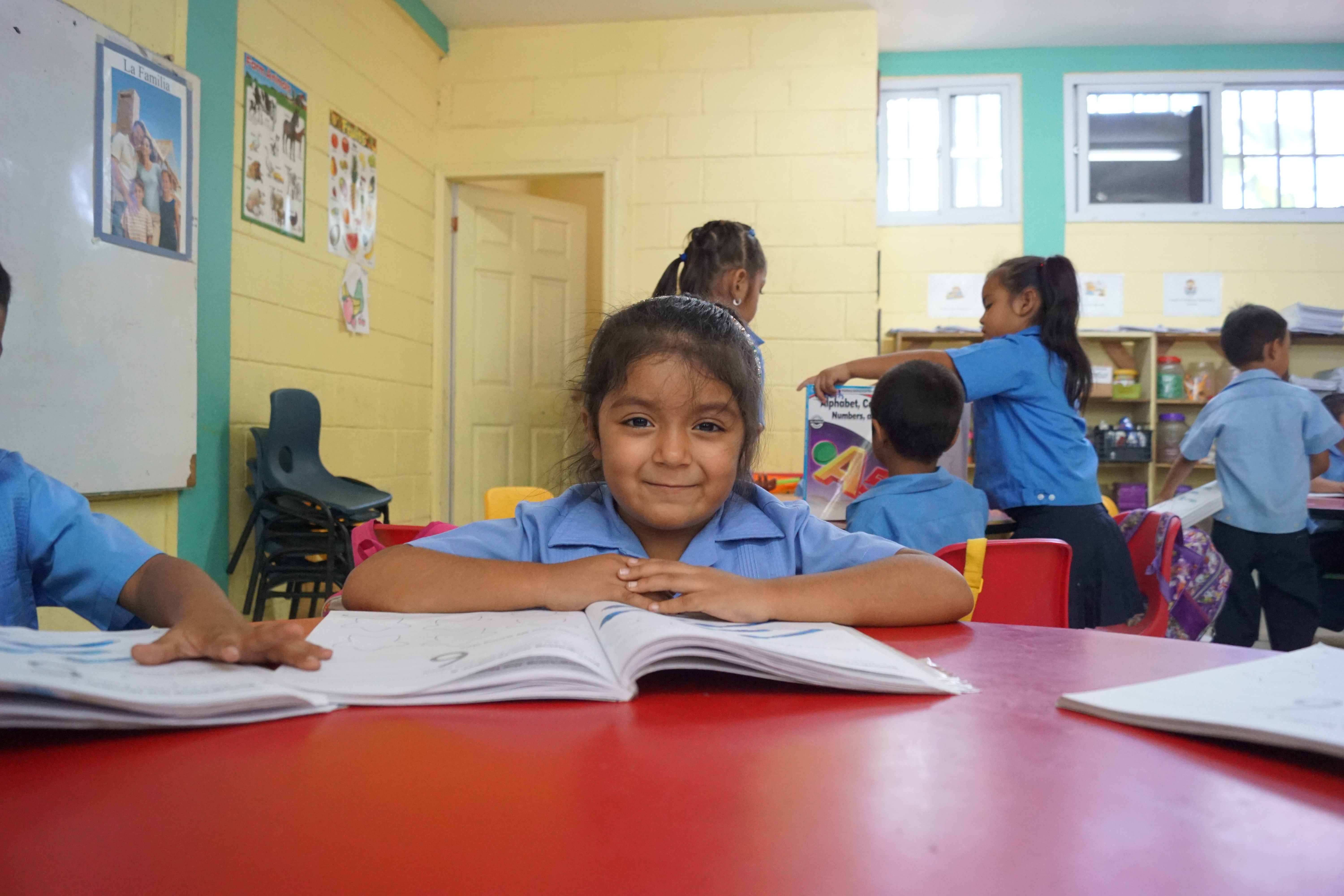 A young student seated with an open workbook in a GK Foundation-supported classroom