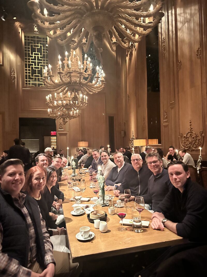 Members of the Vikar team gathered around a long dinner table during the company's first New York offsite