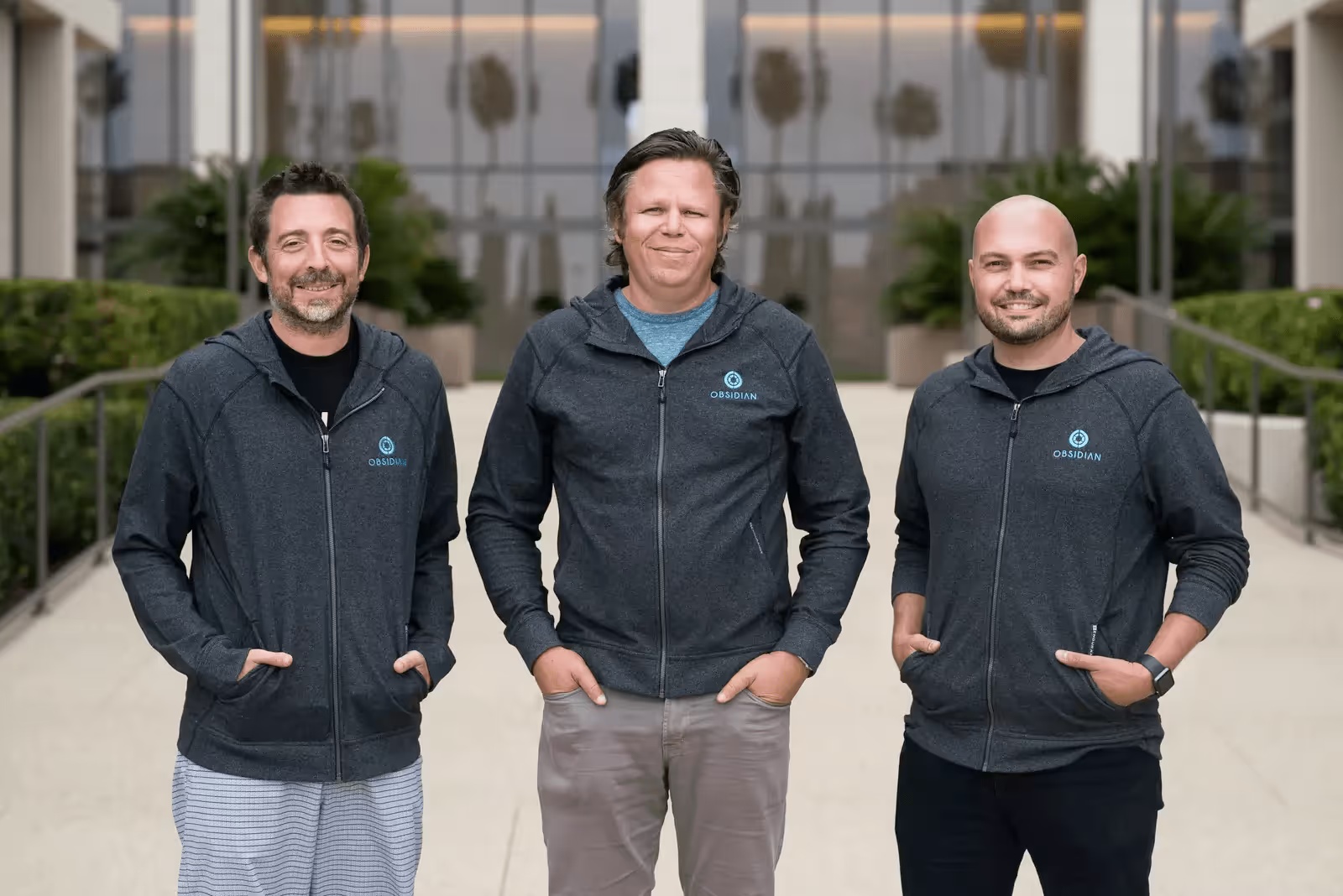 Obsidian co-founders Matt Wolff, Glenn Chisholm and Ben Johnson standing together outdoors