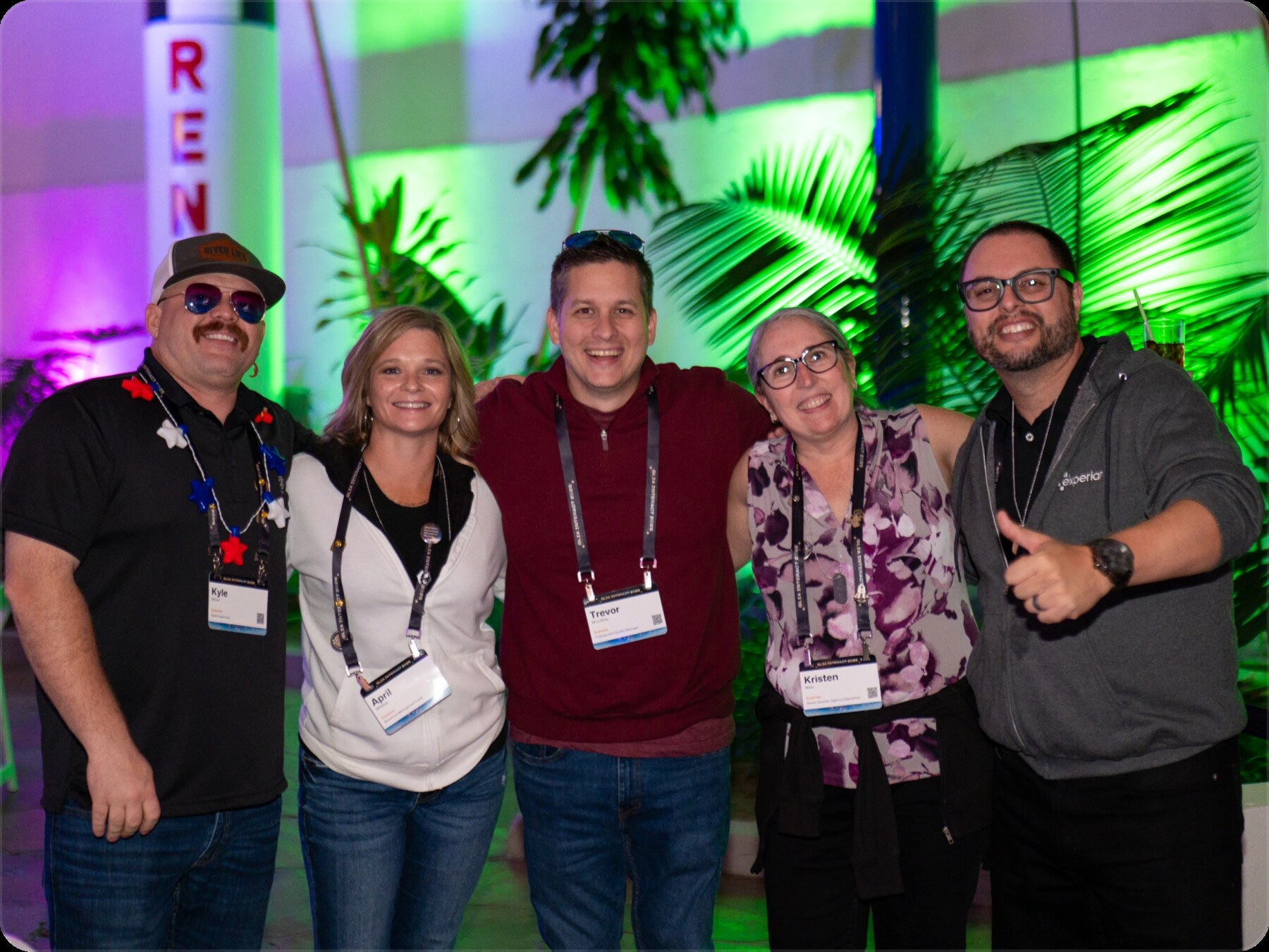 Members of the Glia customer community smiling together at an industry event