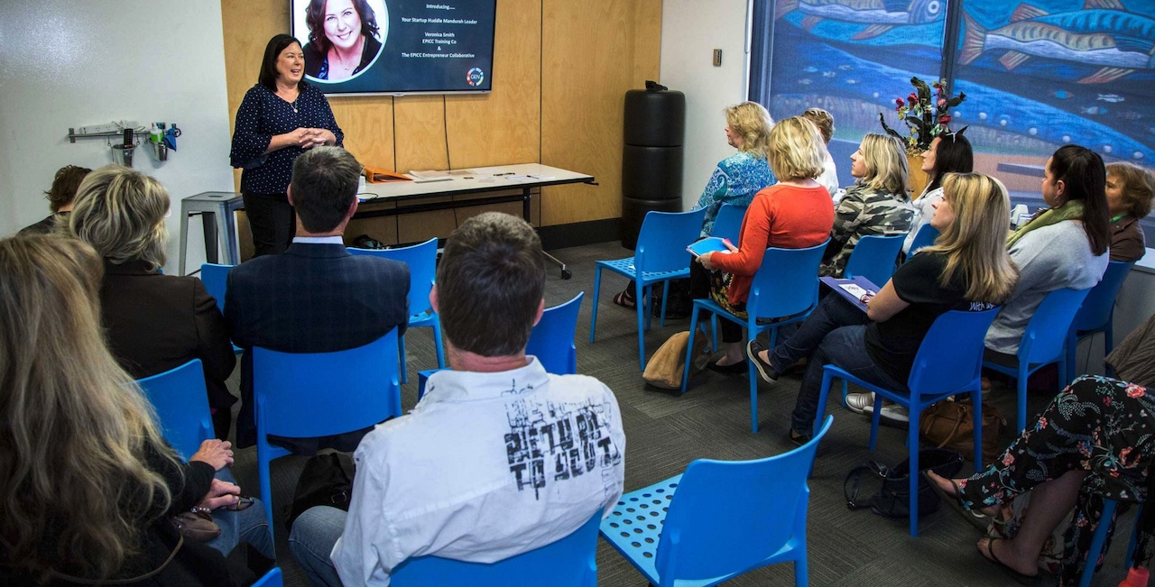 A presenter addresses an audience seated in blue chairs at Startup Huddle in Mandurah, Australia