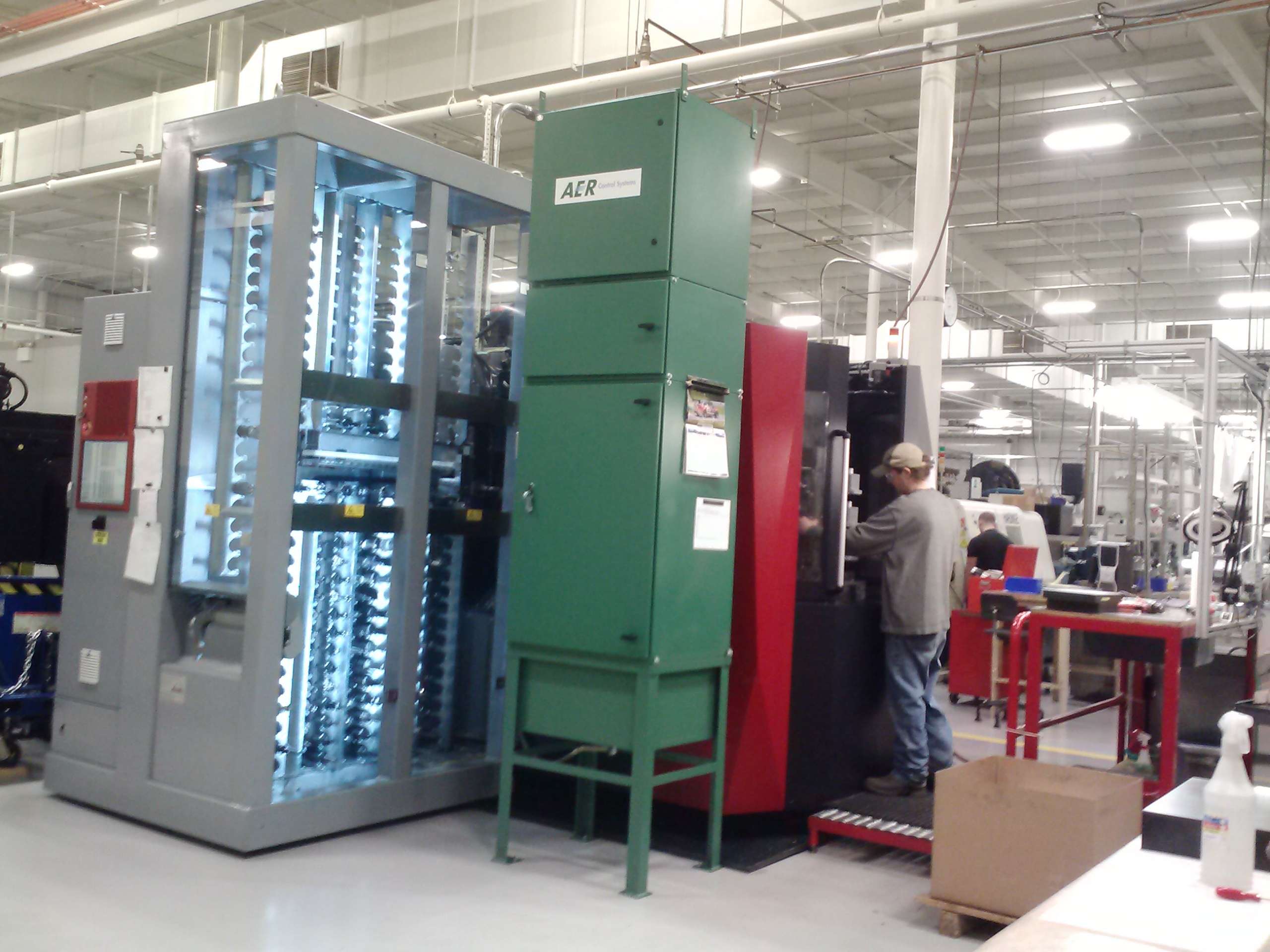 Production equipment and workers on the Magnus Precision Manufacturing shop floor