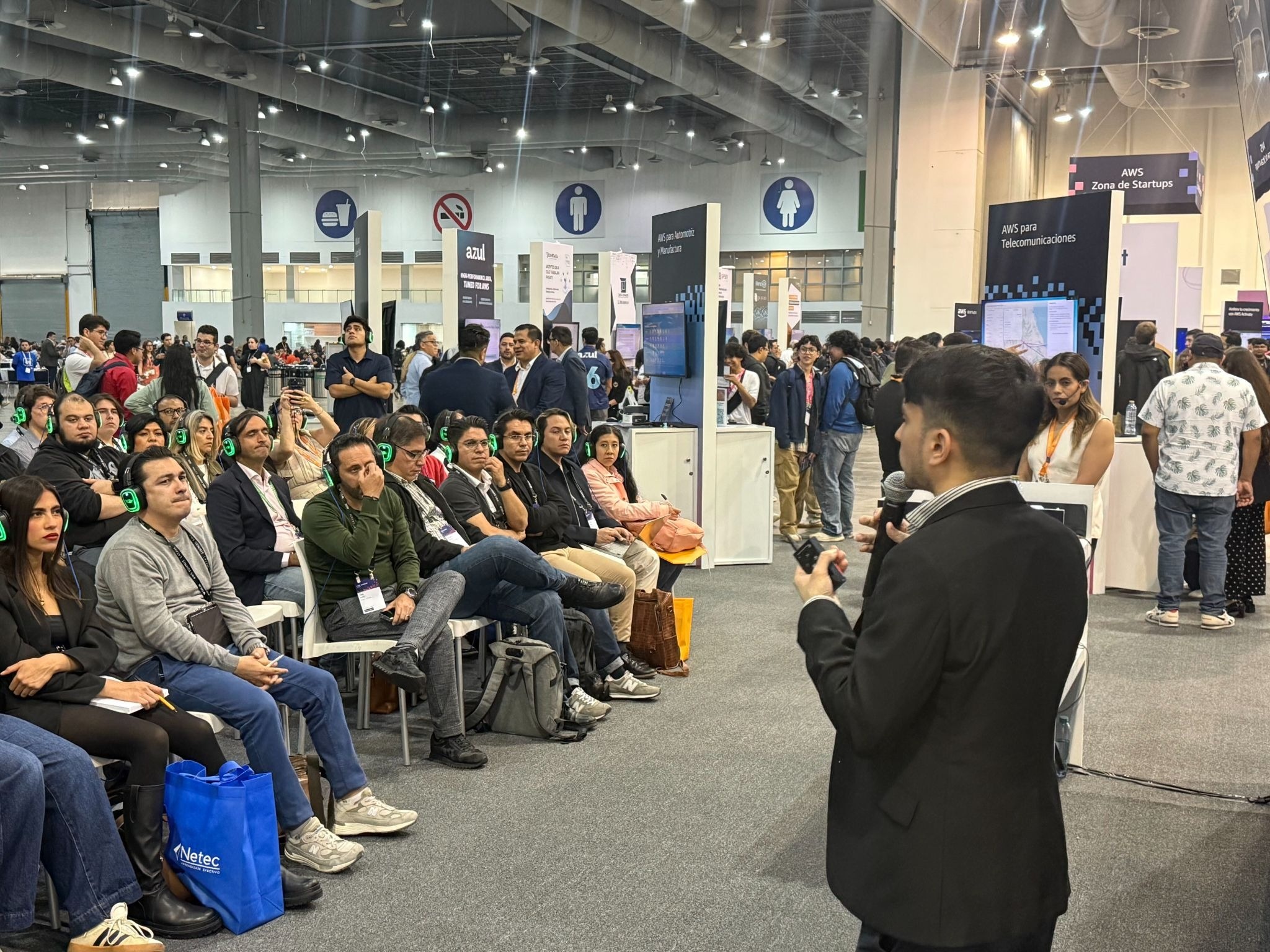 Speaker addressing seated attendees at an AWS Summit Mexico industry presentation