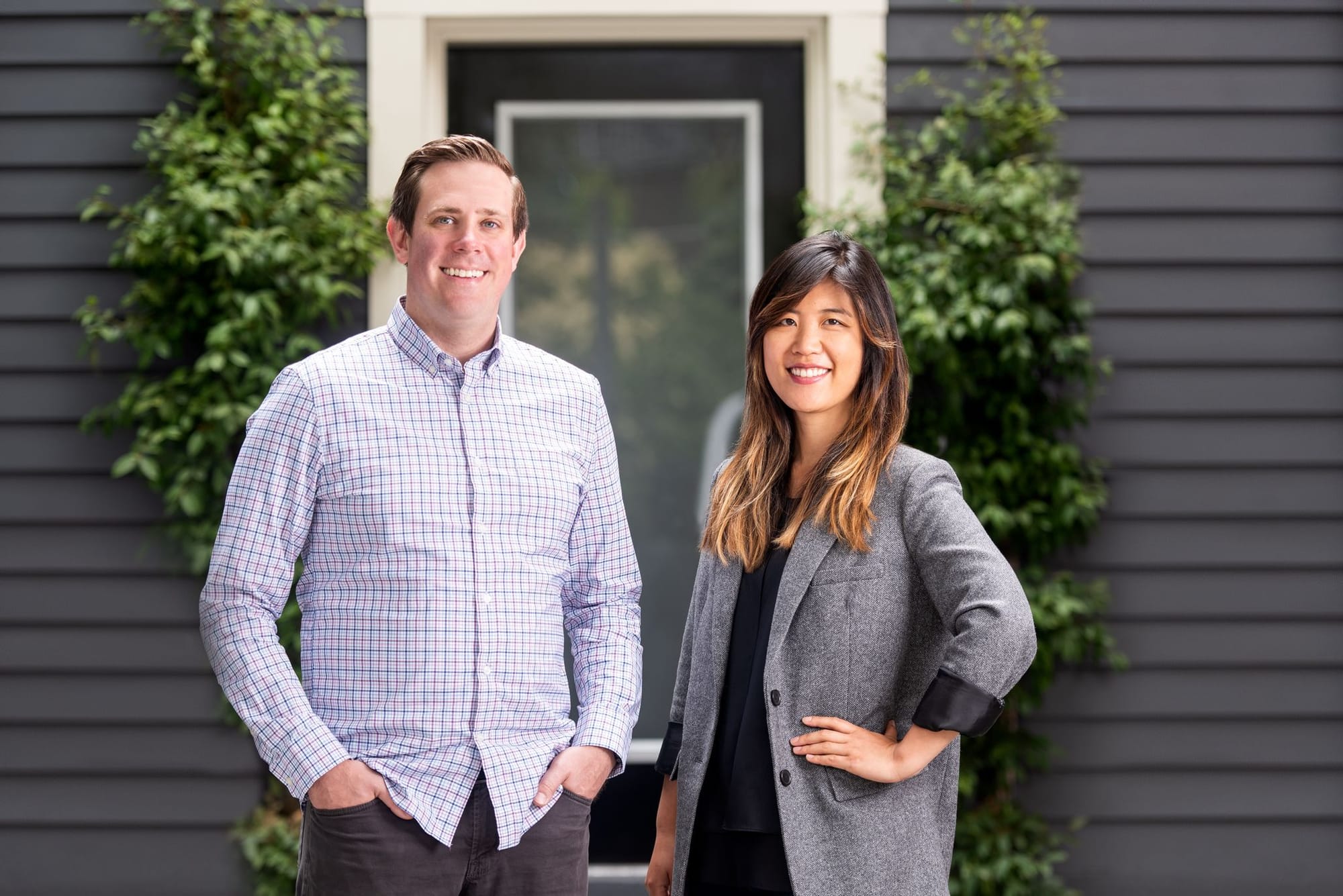 Joel Poloney, left, and Gloria Lin standing together outside a building