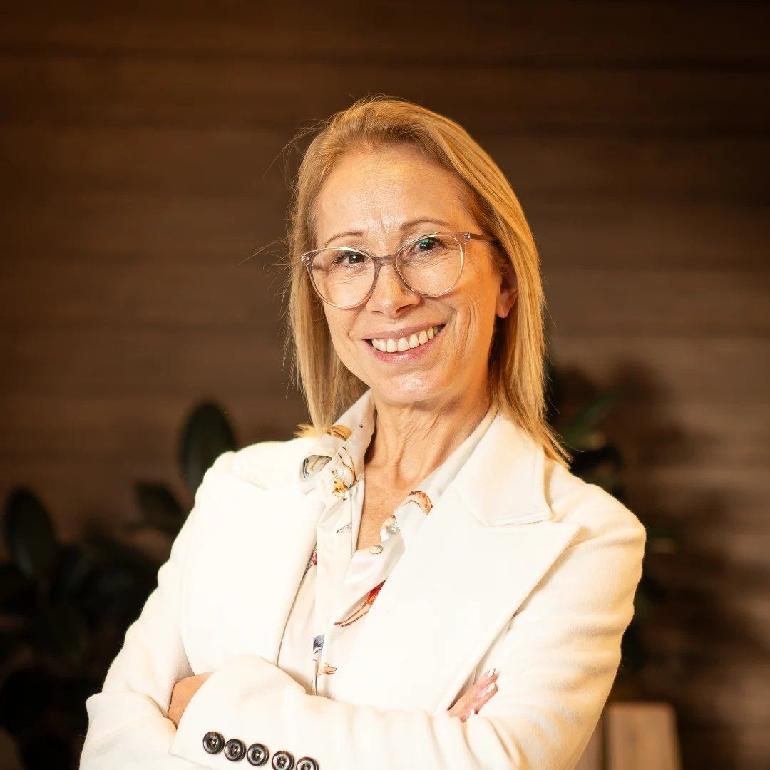 Gloria Rojas wearing glasses and a white blazer