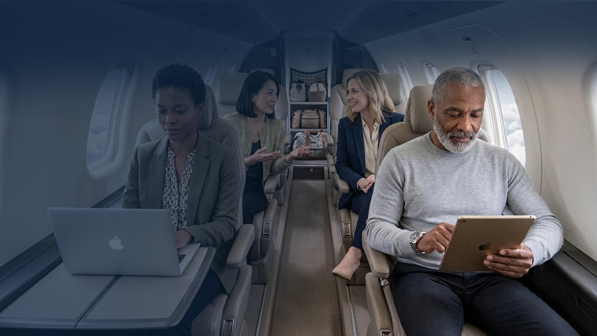 Passengers using connected devices inside a business aircraft cabin