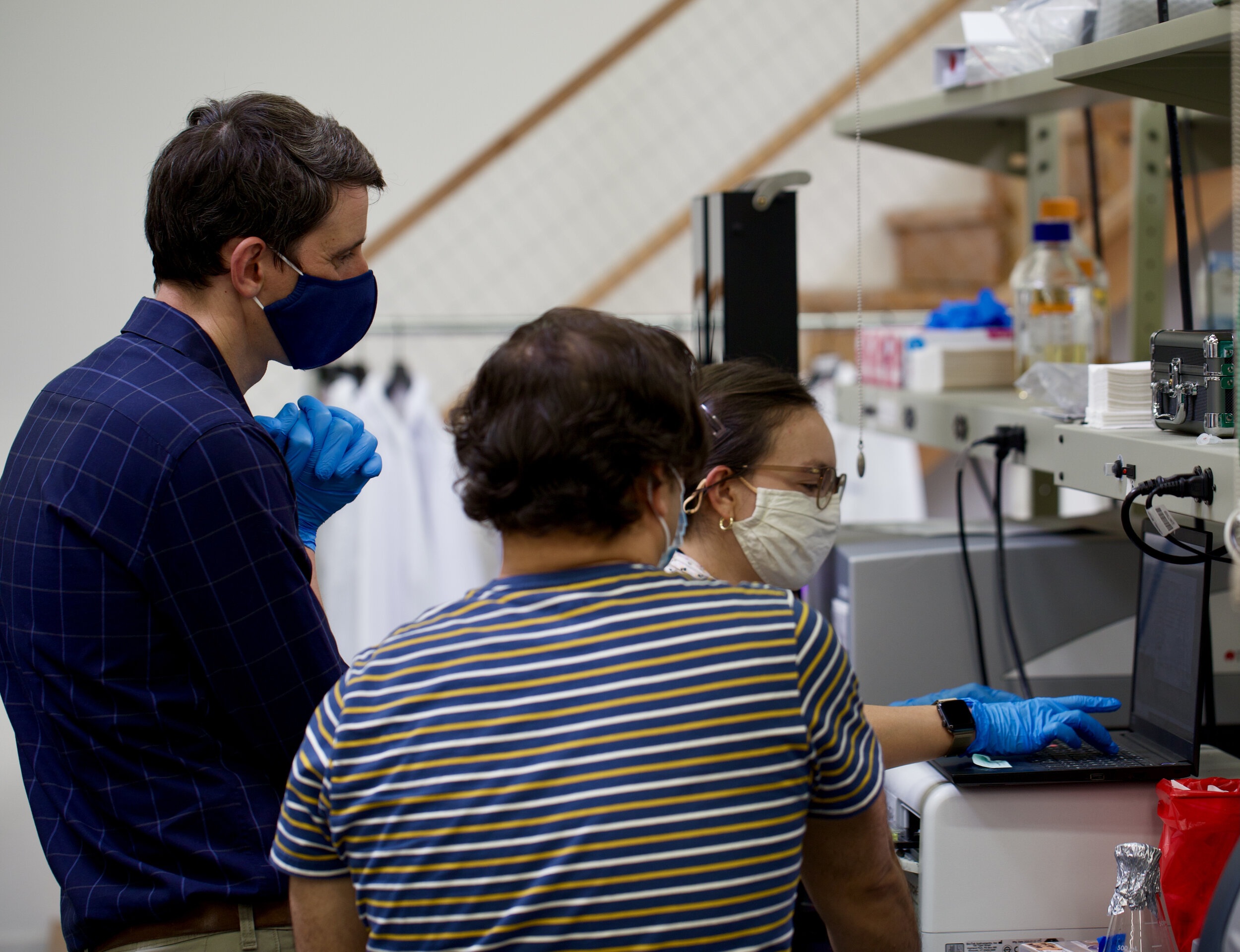 Gonzalo Fuenzalida, at left, working alongside colleagues at an Andes laboratory bench