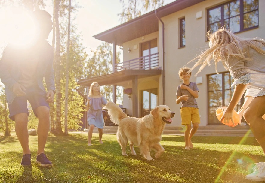 Family playing outside a modern home