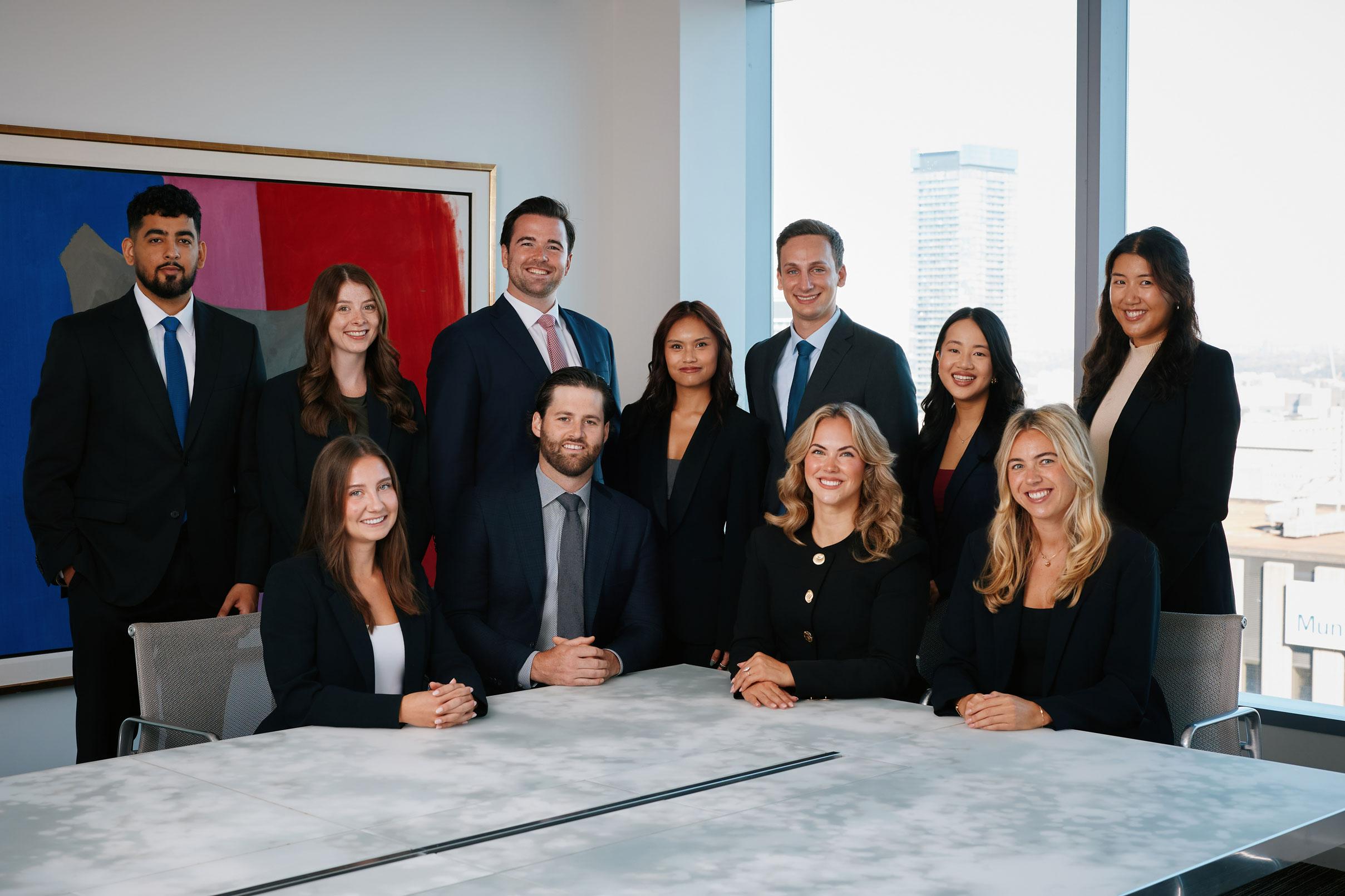 A group of Goodmans associates gathered around a conference table in the firm's Toronto office