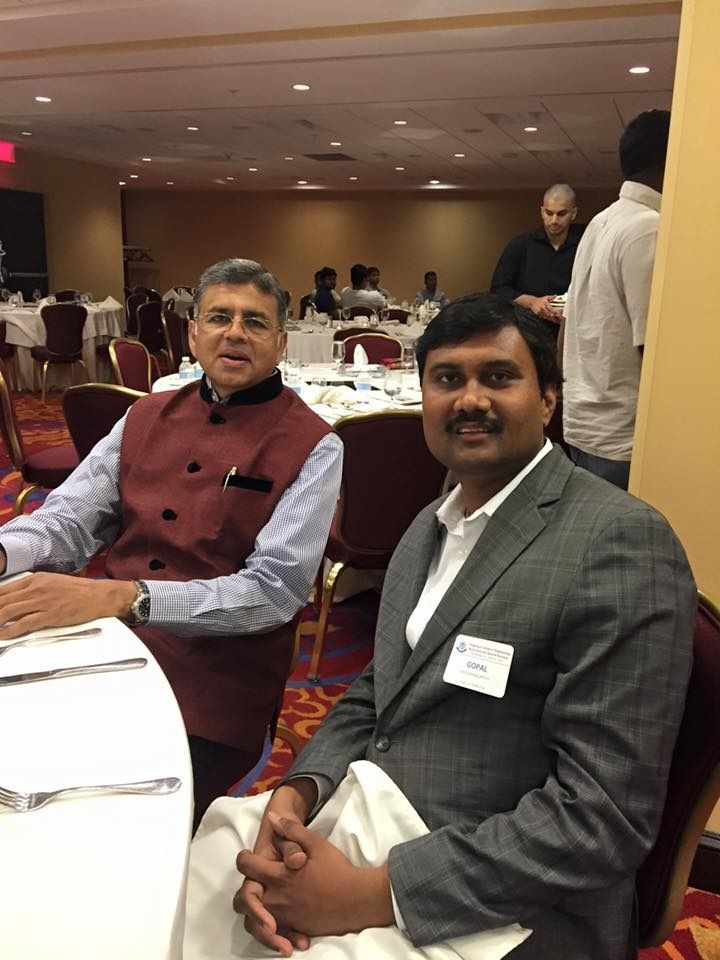 Gopal Krishnamurthy seated beside Kannan at a formal gathering