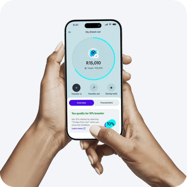 Hands holding a phone showing a GoalSave savings pocket for a dream car