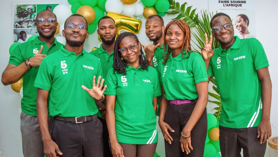 Gozem team members in green shirts posing together