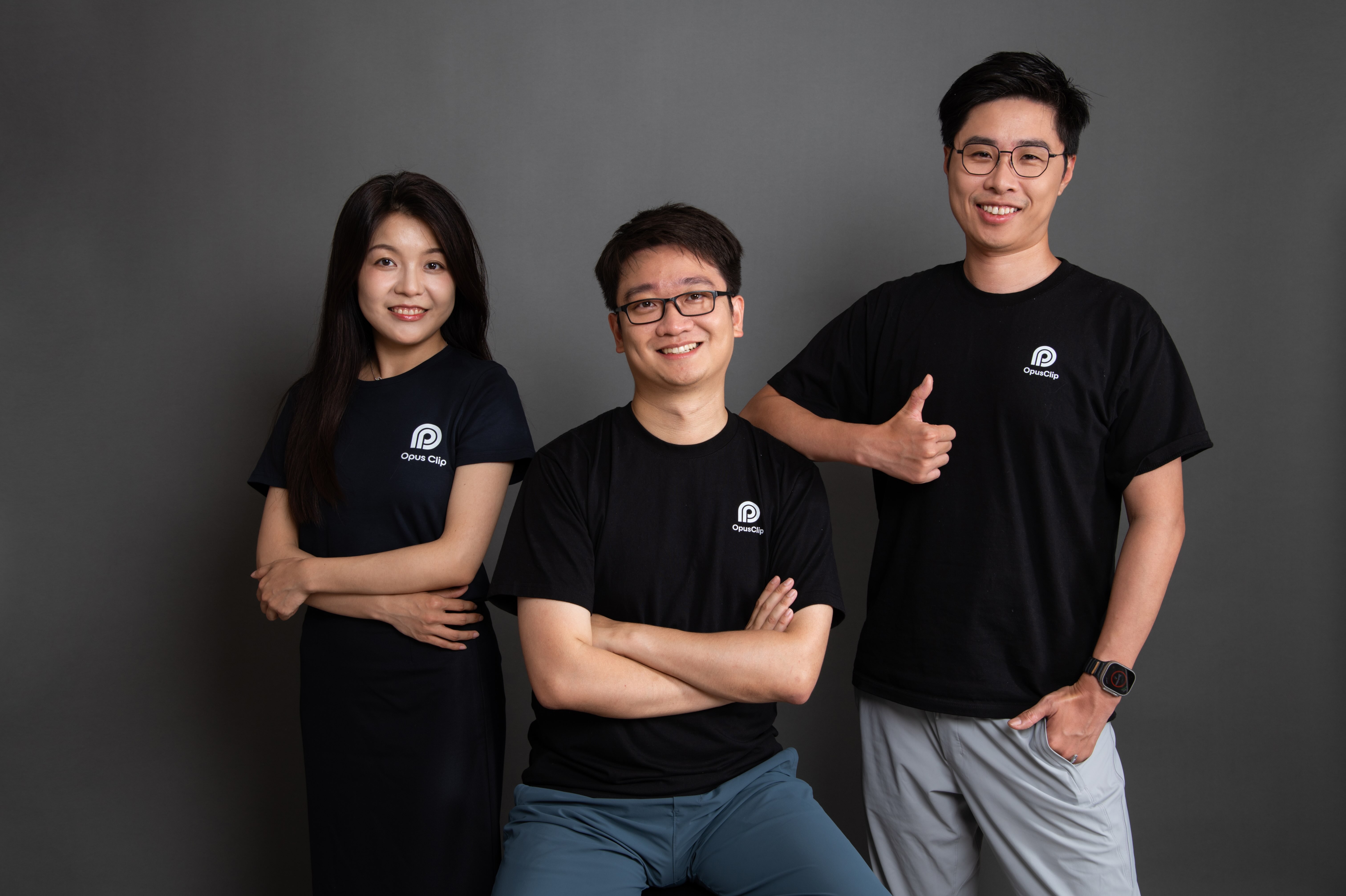 OpusClip founders Grace Wang, Young Zhao and Jay Wu wearing black company shirts against a gray studio background