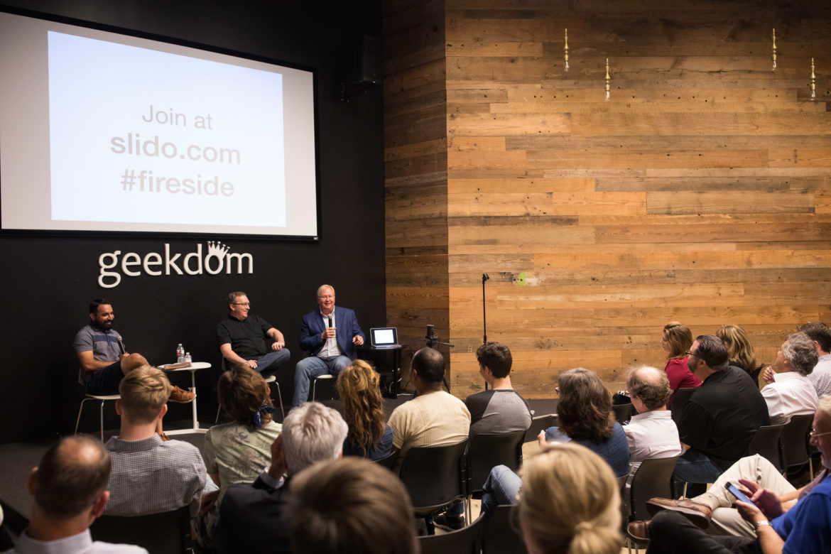 Lorenzo Gomez moderates a Geekdom conversation with Nick Longo and Graham Weston before a seated audience.