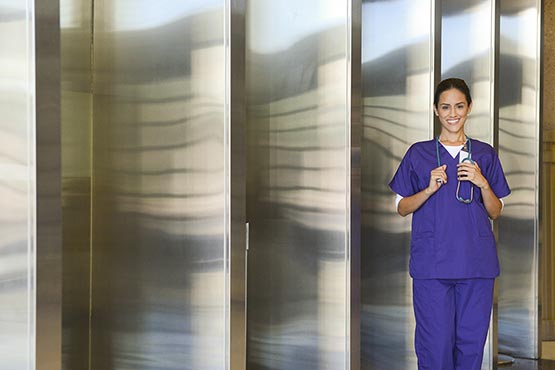 Healthcare professional in purple scrubs in GCE’s Orbis promotional image