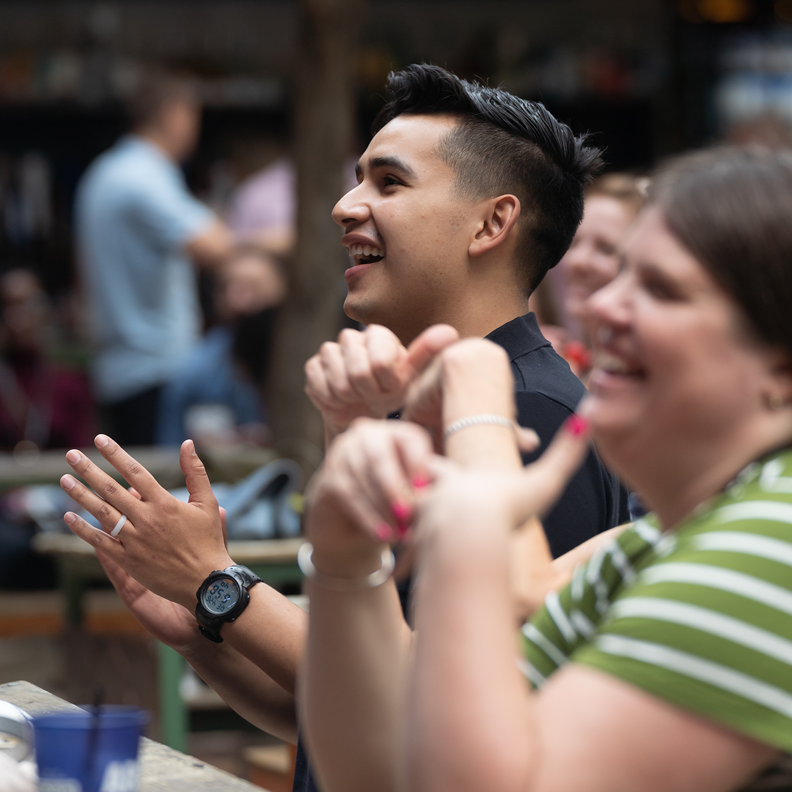 Attendees laughing and applauding at a Simpleview Summit event
