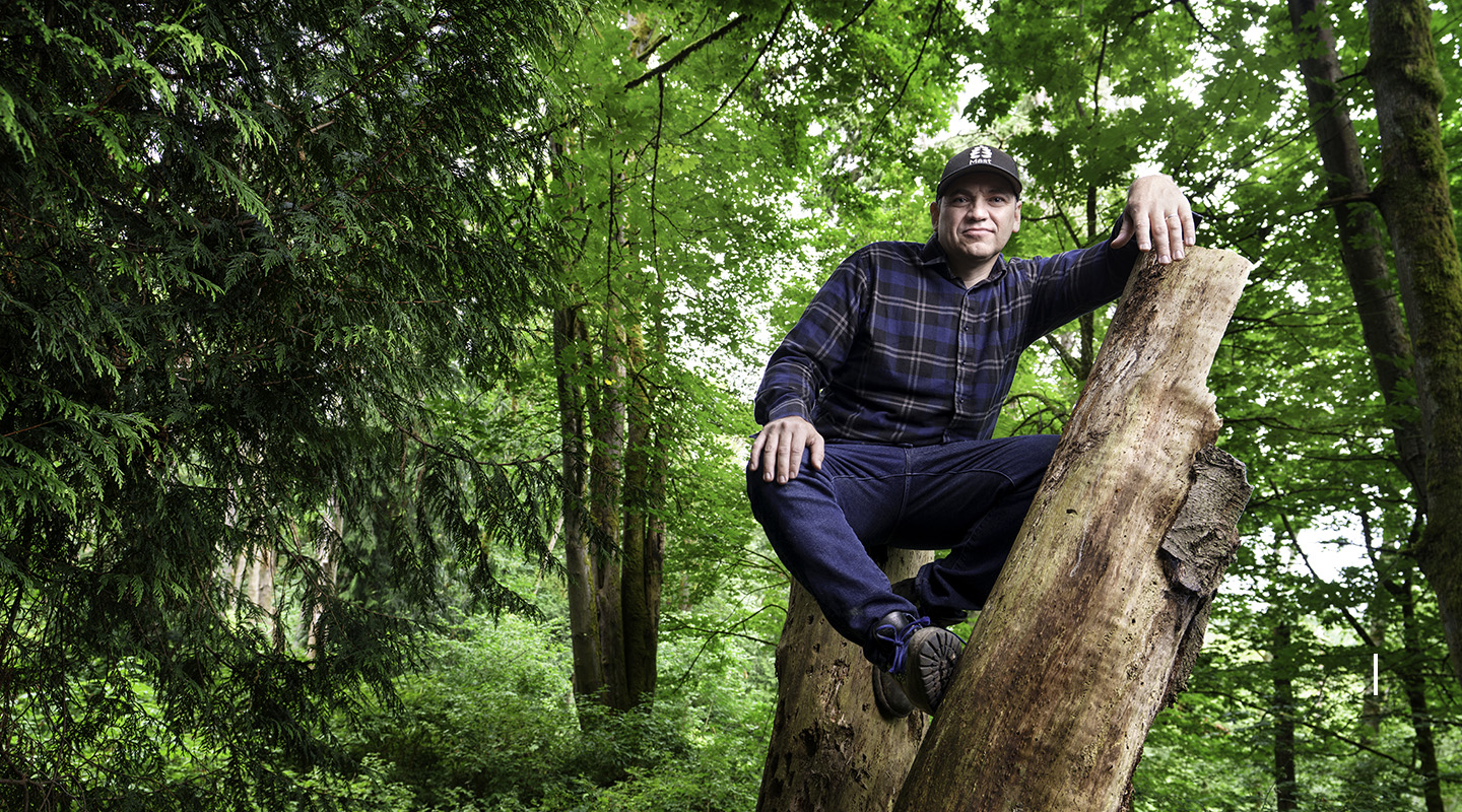 Grant Canary sitting on a fallen tree in Seattle's Carkeek Park
