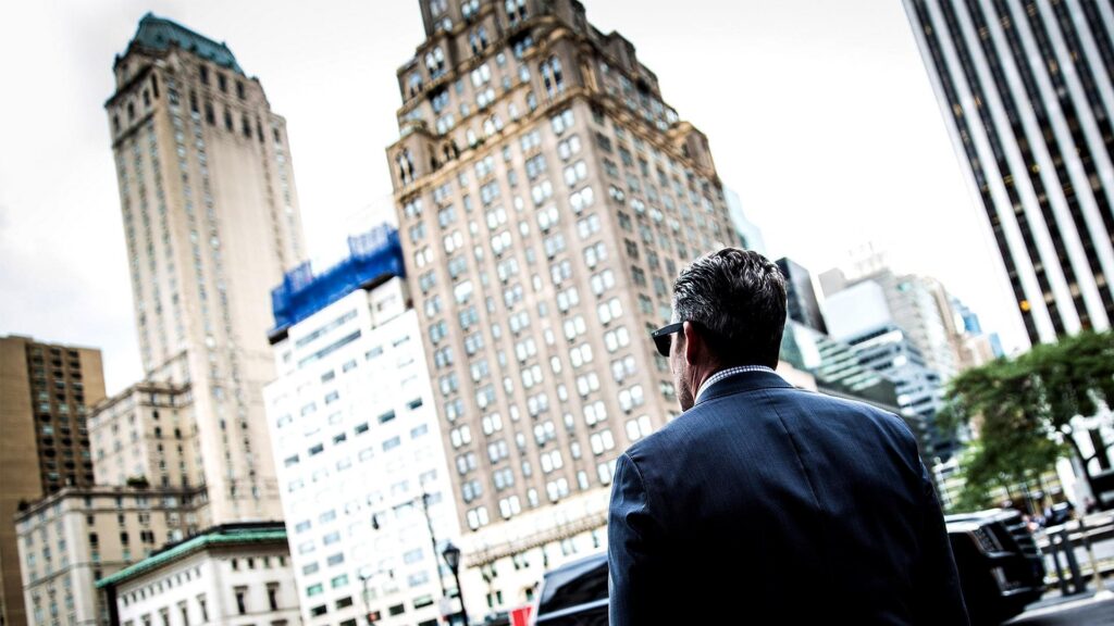 Grant Cardone looking toward city buildings in an official real estate training photograph