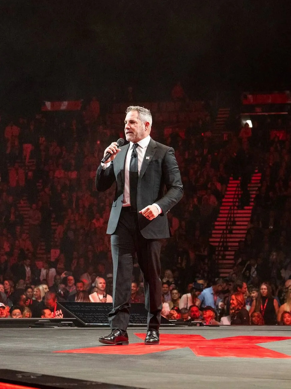 Grant Cardone holding a microphone on stage at the 2025 10X Growth Conference in Las Vegas