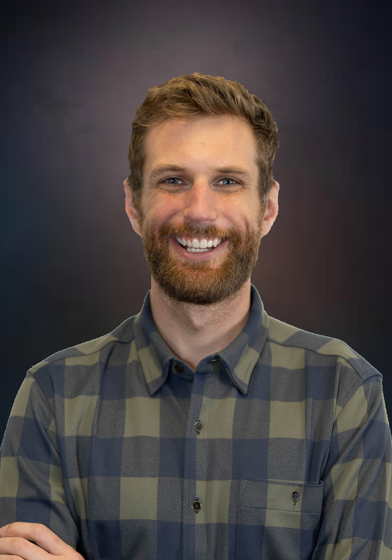 Grant Smith smiling in a checked shirt in an earlier official Stonegrove portrait