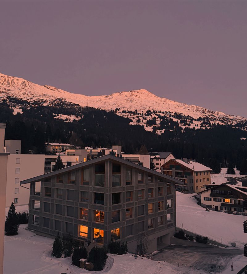 Snow-covered Davos beneath a pink winter sky