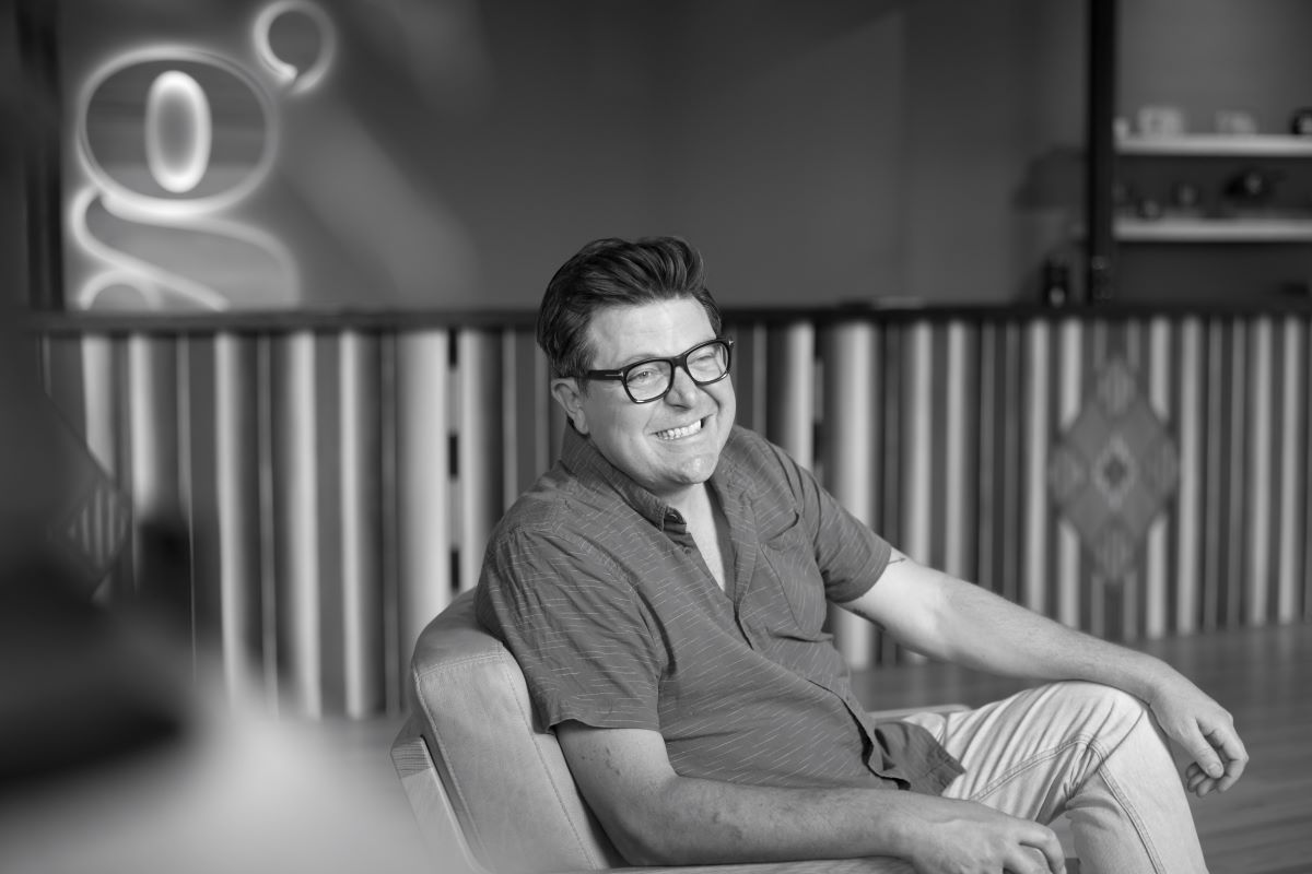 Grasslands founder Ricardo Baca seated in the agency's Denver office