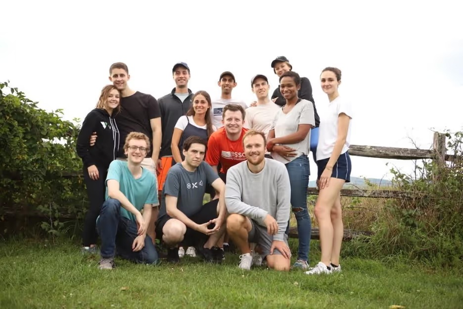 An early Grata team gathered outdoors for a group photograph