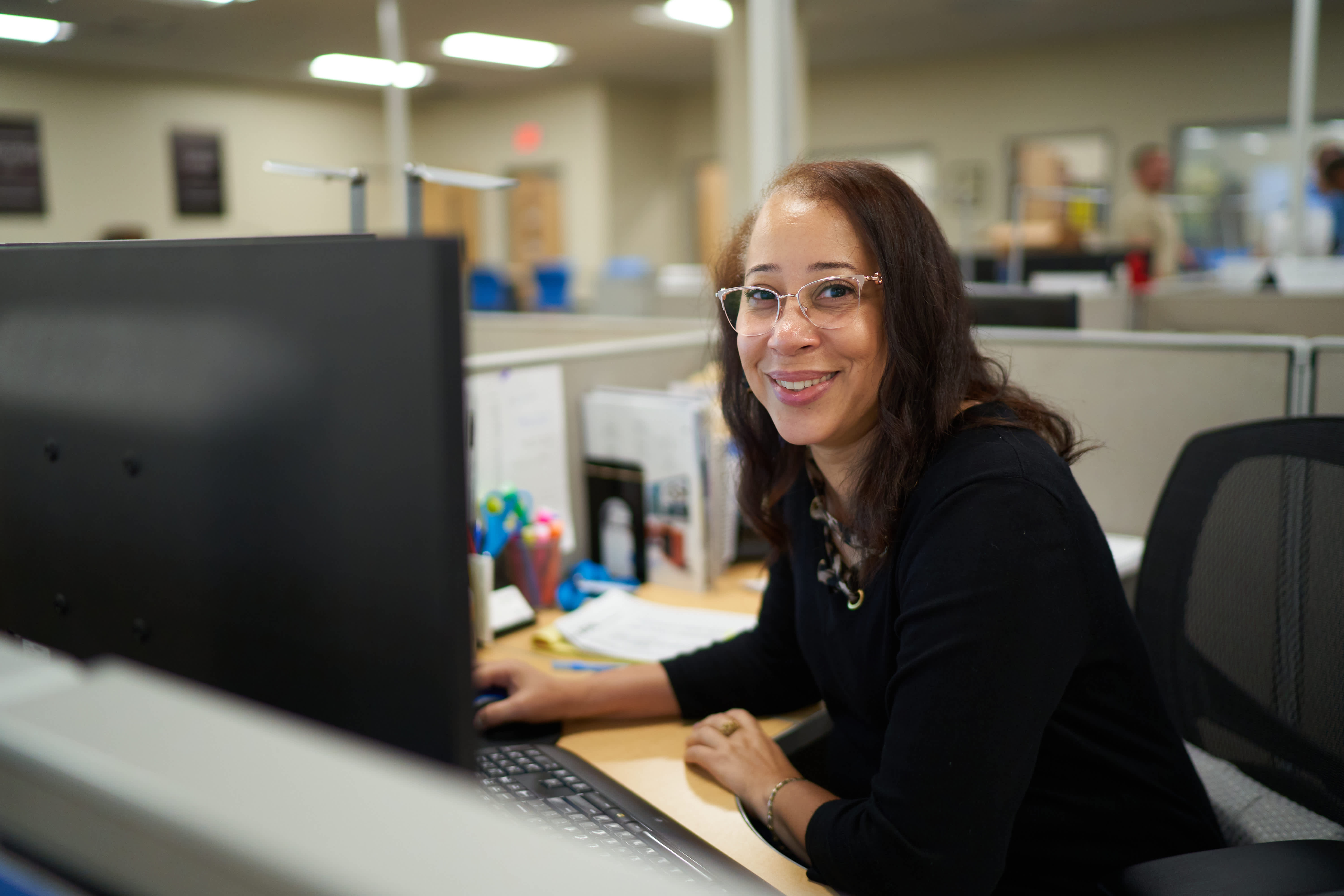 A Graybar employee working at a computer in the company’s Tampa district office