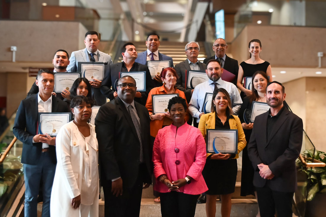 A group holding certificates in the Dallas Accelerator Program gallery