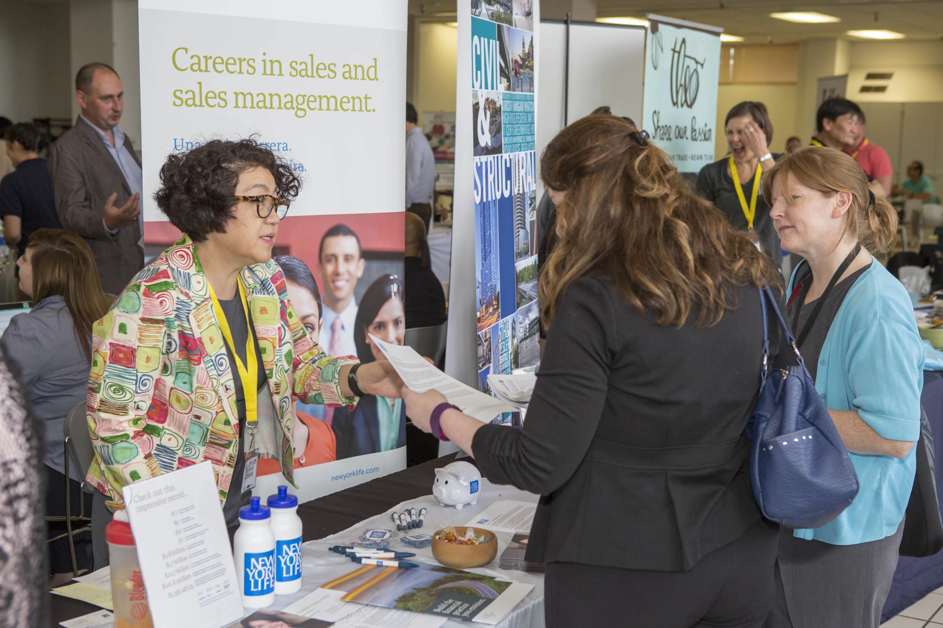 People speaking with employers at a busy Renton career fair