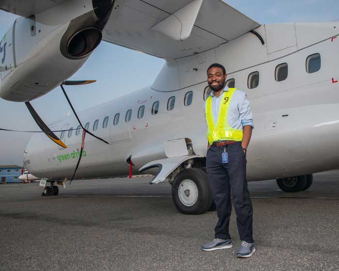 Green Africa founder Babawande Afolabi standing beside an ATR turboprop aircraft
