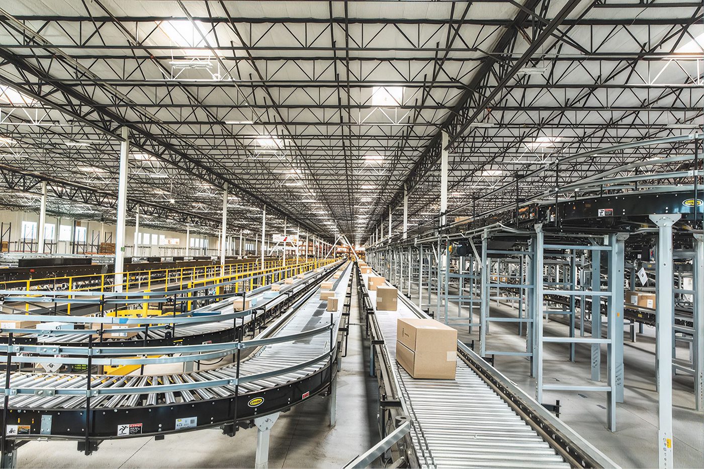 Cartons travel along conveyors through a large distribution center
