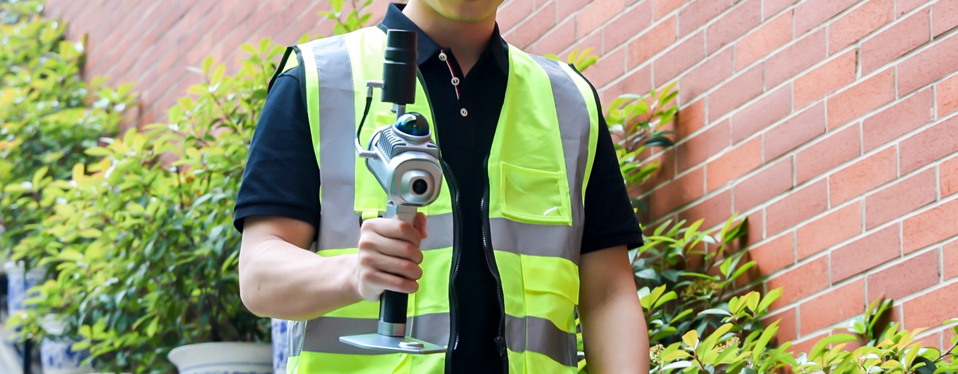 Worker holding a GreenValley handheld laser scanning device