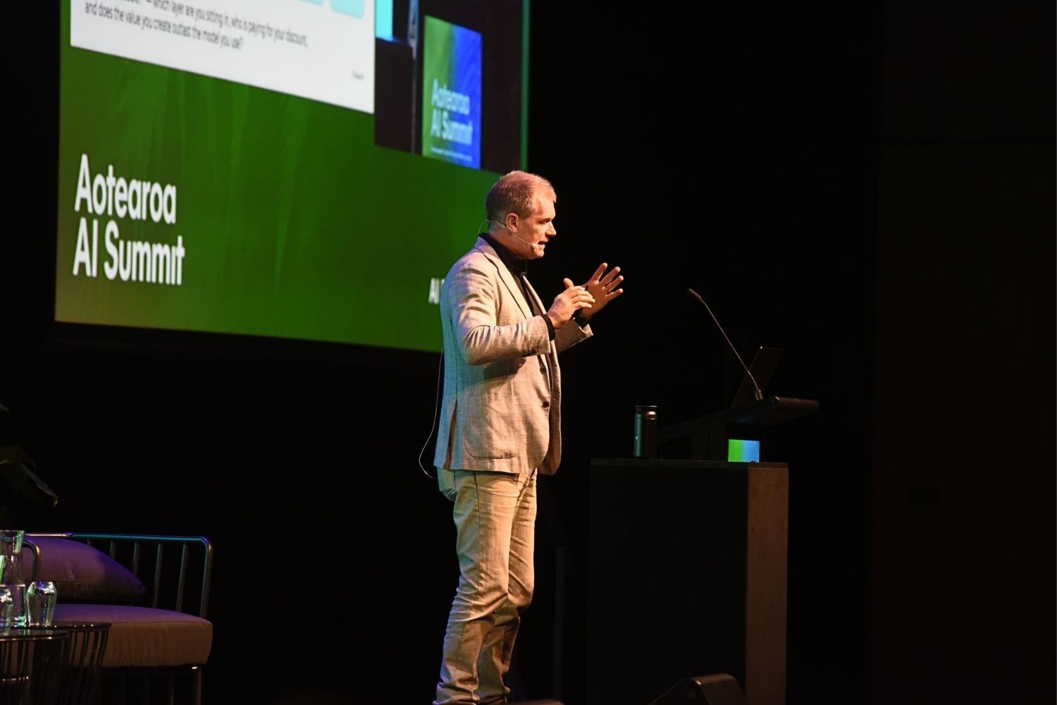 Greg Davidson speaking on stage at the 2026 Aotearoa AI Summit