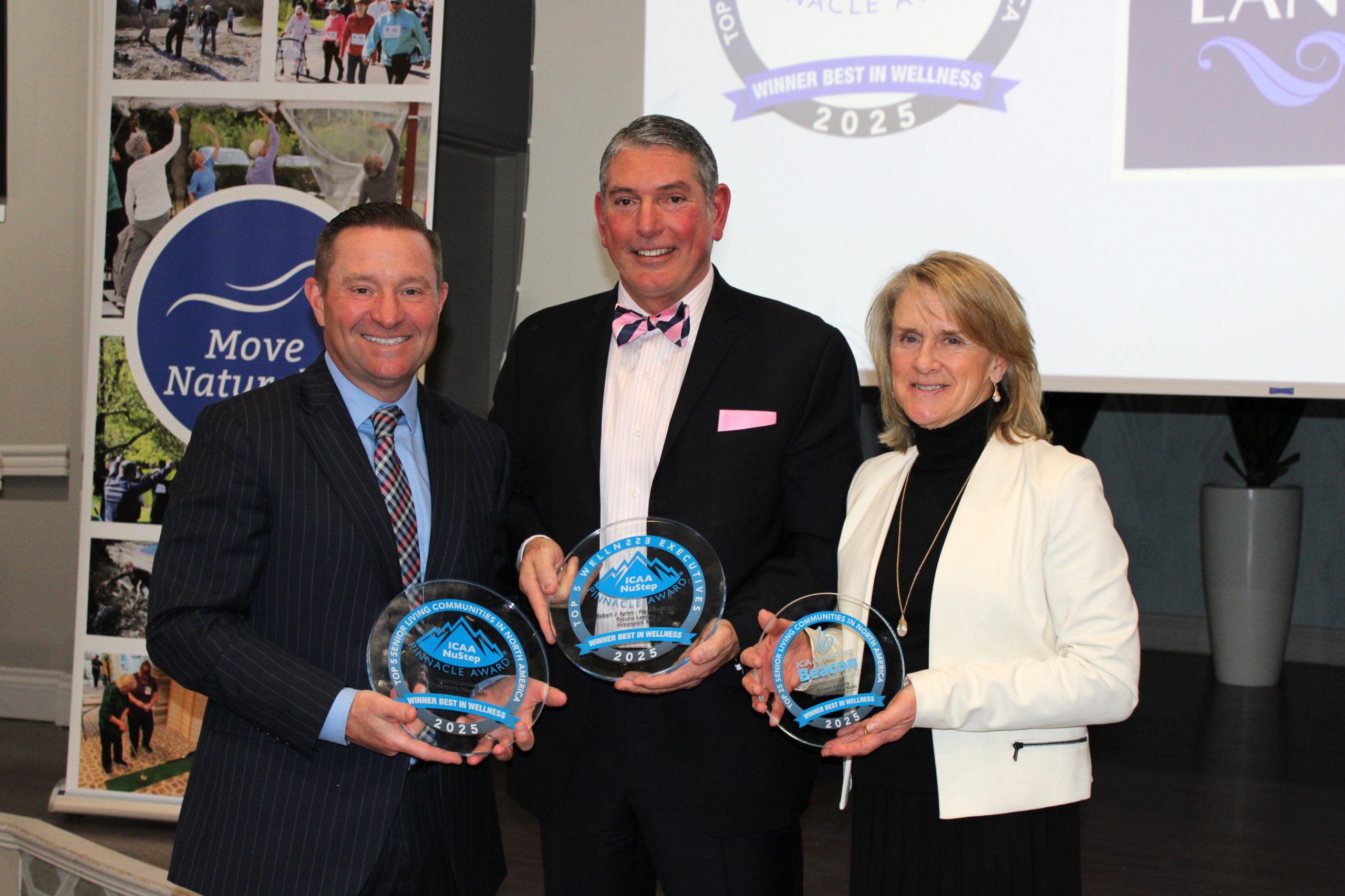 Greg Garrett, Robert Syron and Chrissy Viola holding wellness awards at Peconic Landing