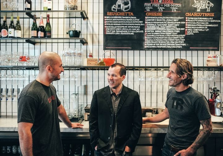 Greg Hong, center, talking with restaurant colleagues at Tar & Roses; chef and owner Andrew Kirschner stands at right.