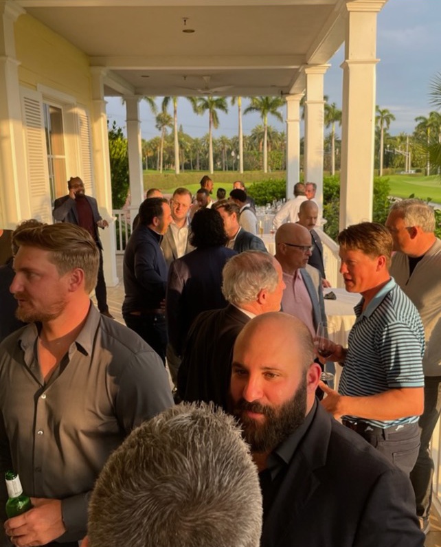 Greg Meerbaum, in the foreground at right, among attendees on a Palm Beach terrace at Coastal’s investor gathering.