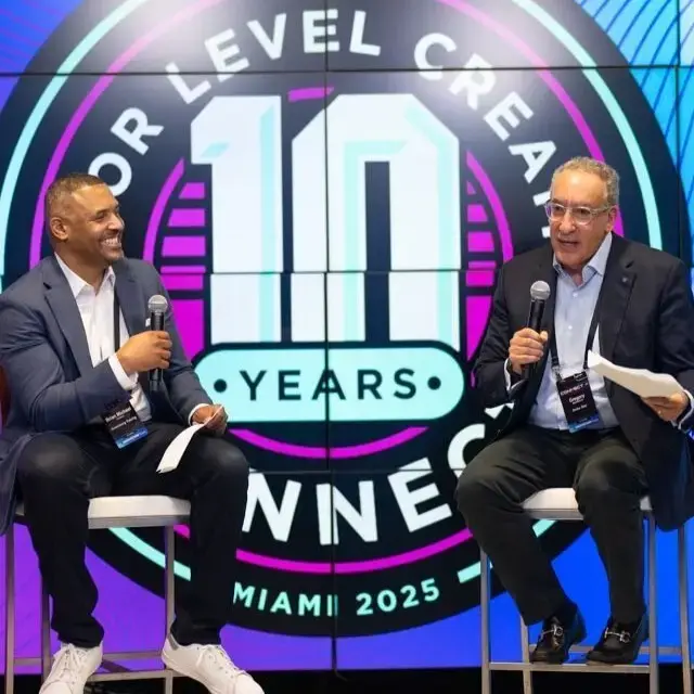Gregory Bedrosian, seated on the right holding a microphone, in a fireside conversation at MLC CONNECT in Miami in 2025