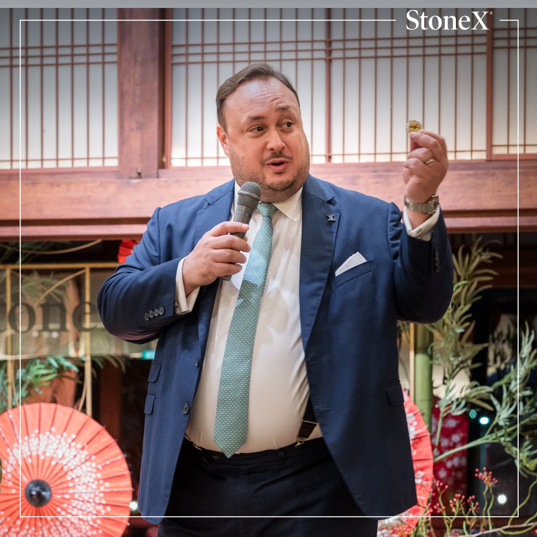 Gregory Kallinikos speaking into a microphone at the StoneX client dinner in Kyoto