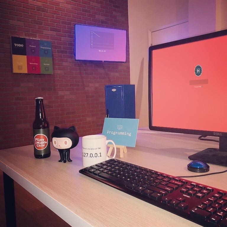 A programming station in Startup Escape, with a keyboard, GitHub figurine and startup task board