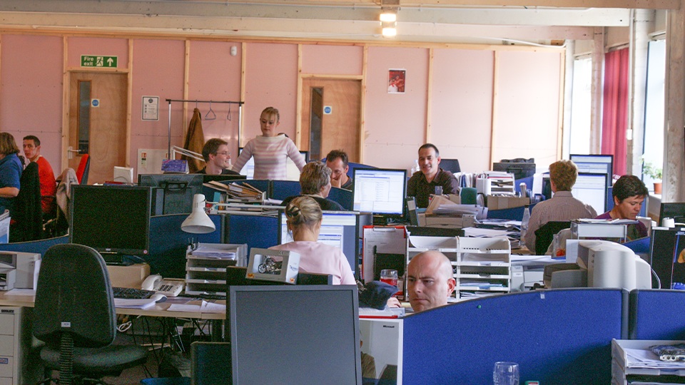 Archive photograph of Grey Matter staff working among monitors, desks and document trays