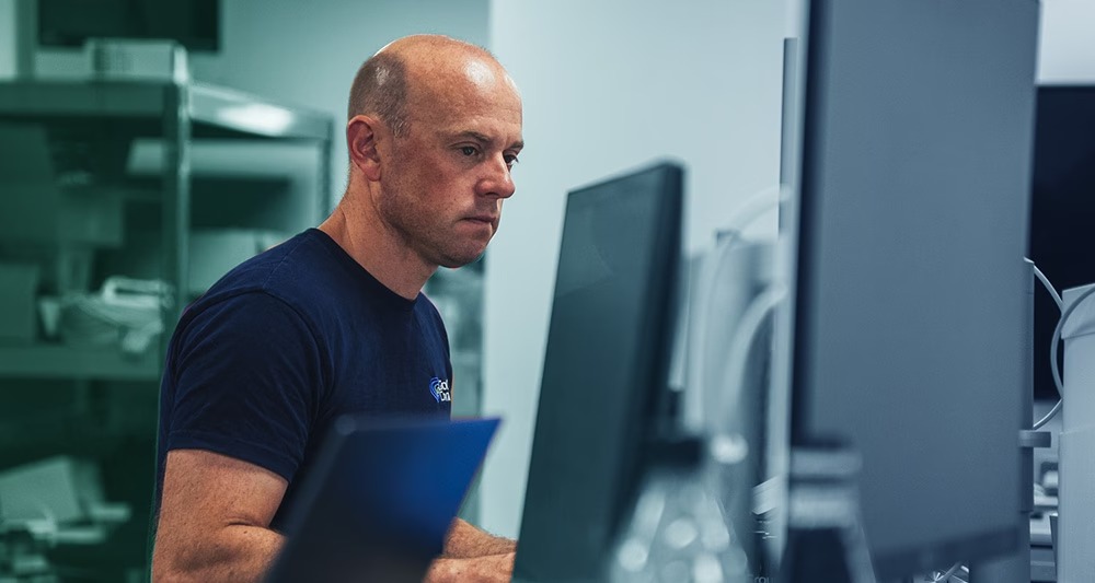 Ground Control CTO and Rock Seven co-founder Ric Searle working at a computer