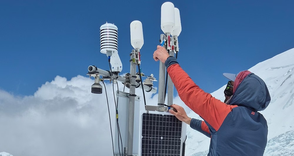 Researchers installing glacier monitoring equipment on Everest