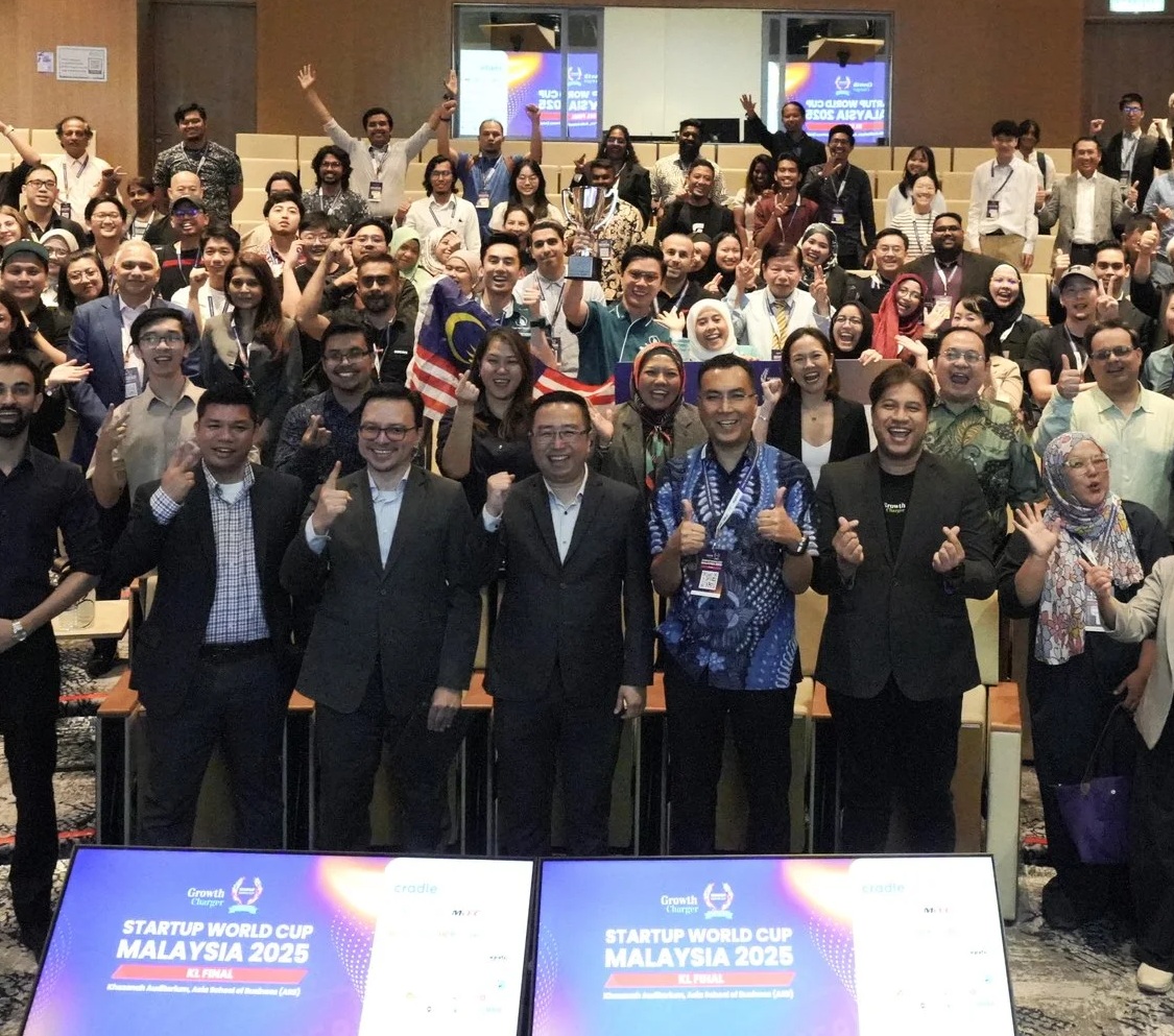 Founders, organisers and partners gather with a trophy at the Startup World Cup Malaysia 2025 Kuala Lumpur final