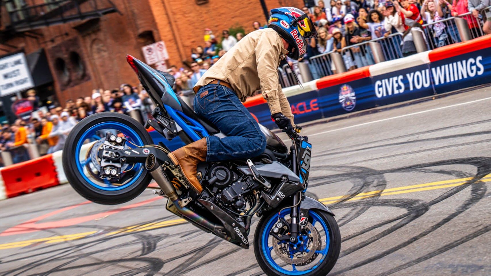 A motorcycle stunt rider performs on Broadway in Nashville during a Red Bull Showrun photographed for Bridgestone Motorcycle